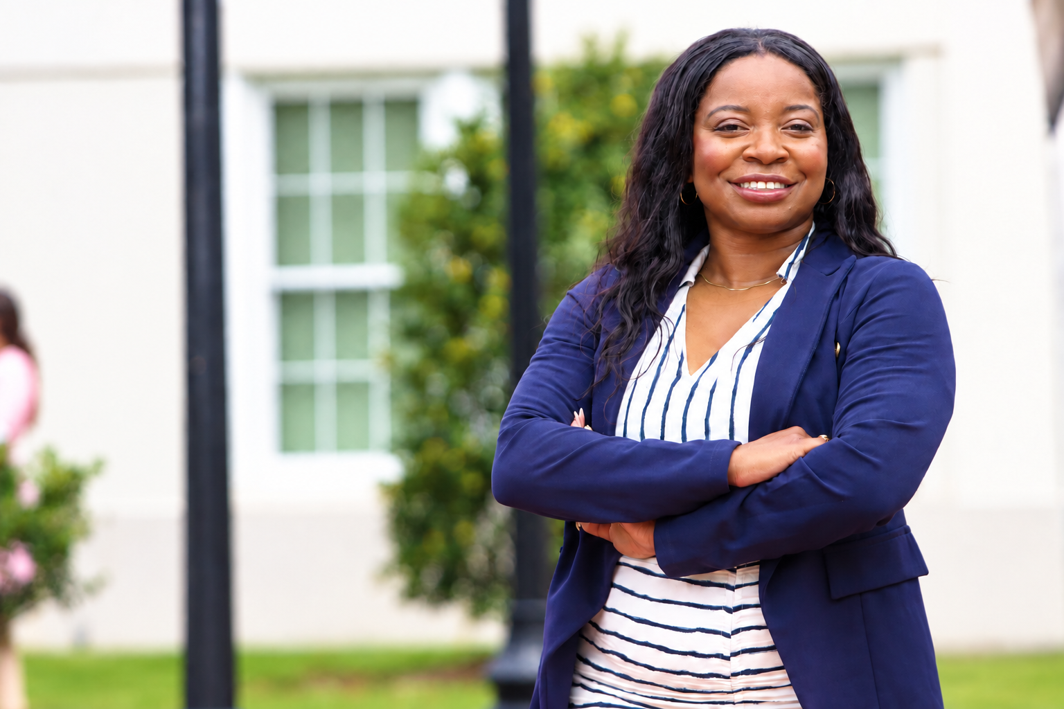 Kelli Sweat with arms crossed, smiling outside